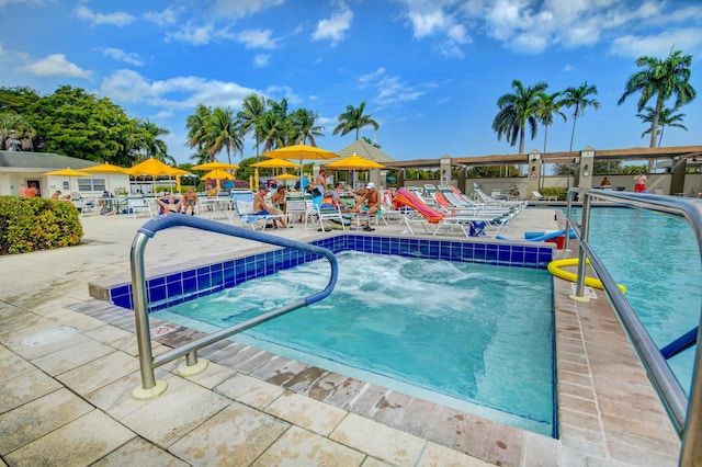 community pool with a patio area