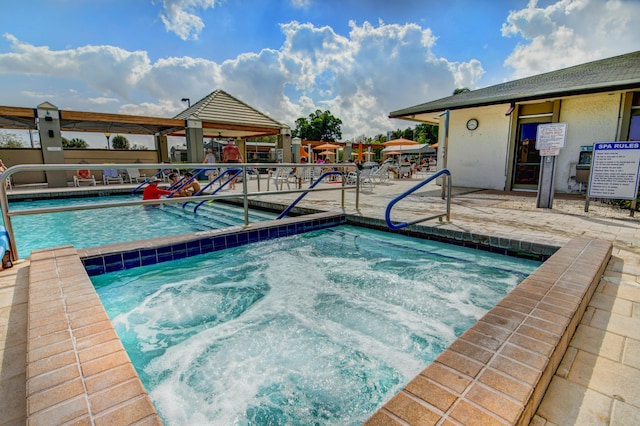 view of pool featuring a patio area and a community hot tub