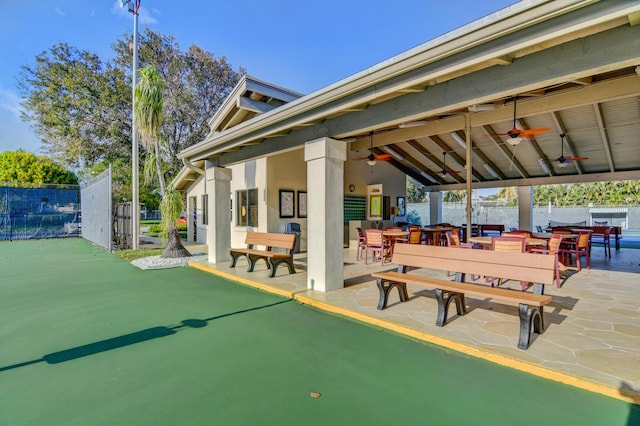 surrounding community featuring outdoor dining area, a patio area, and fence