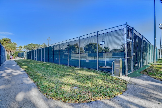 view of tennis court featuring fence