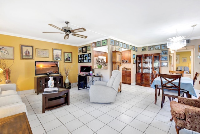 living room with visible vents, ornamental molding, light tile patterned flooring, and ceiling fan with notable chandelier