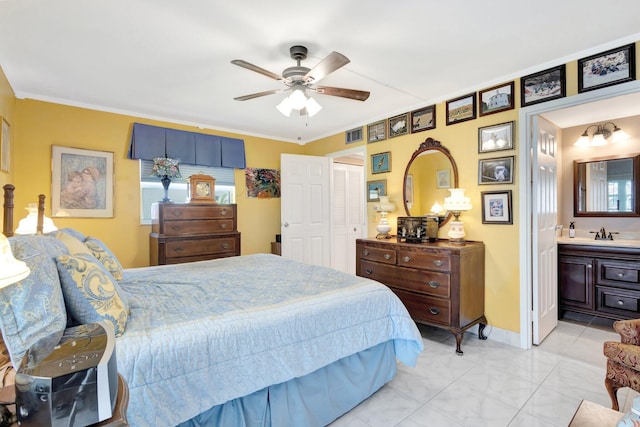 bedroom with a closet, ornamental molding, a ceiling fan, and light tile patterned flooring