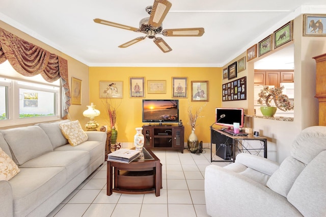 living room featuring light tile patterned flooring, crown molding, and ceiling fan