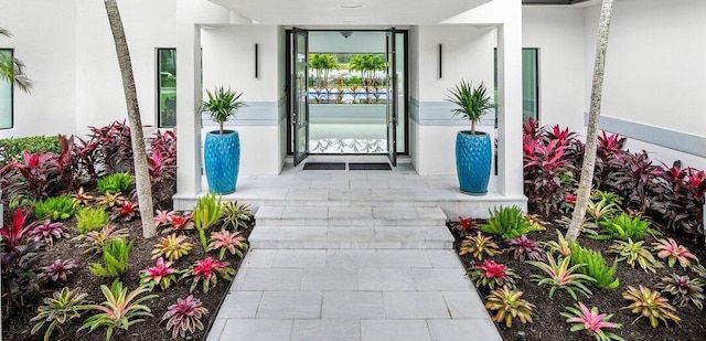 property entrance with stucco siding