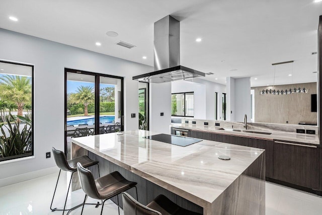 8387 Sawpine Rd, Delray Beach, FL 33446 - kitchen with modern cabinets, island range hood, black electric cooktop, a spacious island, and plenty of natural light