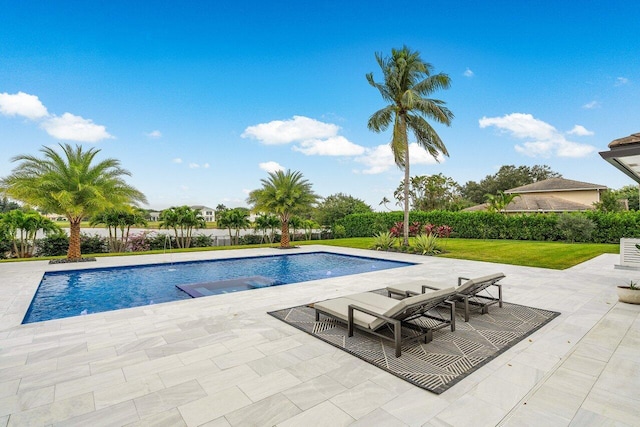 view of swimming pool featuring a fenced in pool, a lawn, a jacuzzi, and a patio area