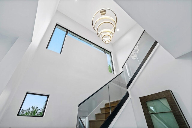 8387 Sawpine Rd, Delray Beach, FL 33446 - staircase with a towering ceiling and a chandelier