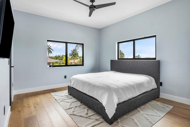 8387 Sawpine Rd, Delray Beach, FL 33446 - bedroom with multiple windows, wood-type flooring, and baseboards