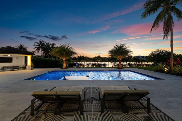 8387 Sawpine Rd, Delray Beach, FL 33446 - pool at dusk with a patio area and an outdoor pool