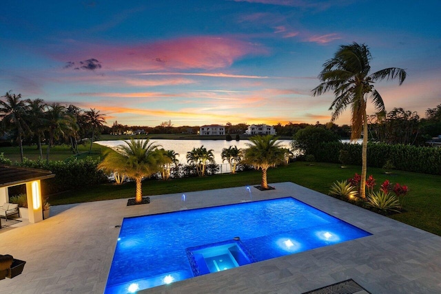 8387 Sawpine Rd, Delray Beach, FL 33446 - pool at dusk featuring a lawn, a patio area, a pool with connected hot tub, and a water view