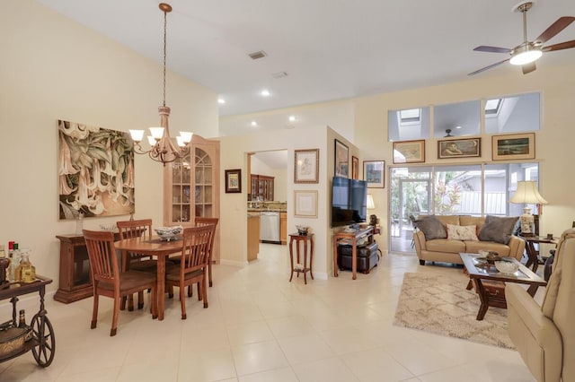 dining space with ceiling fan with notable chandelier, recessed lighting, and high vaulted ceiling