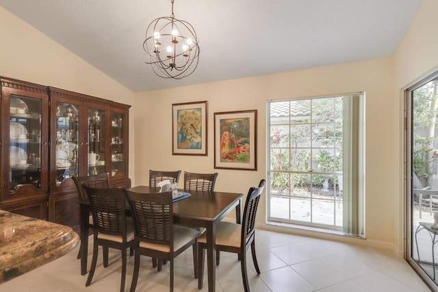 dining space featuring lofted ceiling, a notable chandelier, and light tile patterned flooring