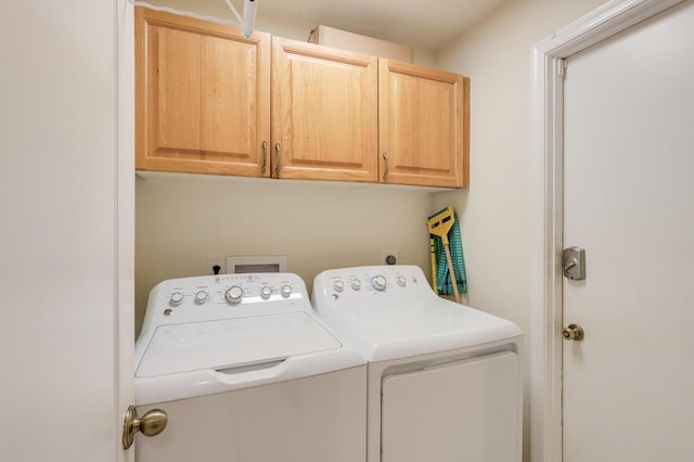 washroom featuring cabinet space and independent washer and dryer