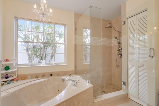 bathroom featuring a closet, a garden tub, an inviting chandelier, and a stall shower