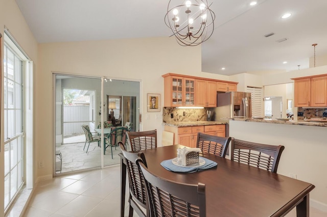 dining area with recessed lighting, a notable chandelier, a healthy amount of sunlight, and light tile patterned flooring