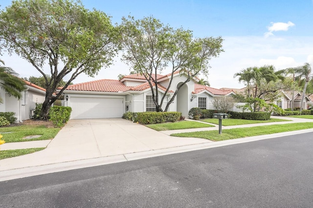 mediterranean / spanish house with stucco siding, driveway, a front yard, an attached garage, and a tiled roof