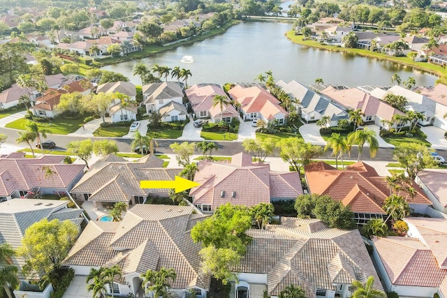 drone / aerial view with a residential view and a water view