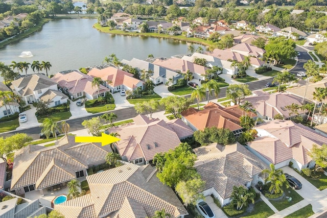 drone / aerial view featuring a residential view and a water view