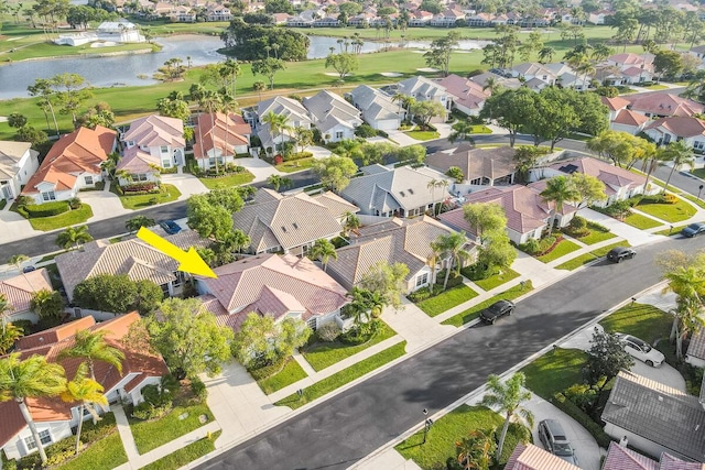 aerial view with golf course view, a residential view, and a water view