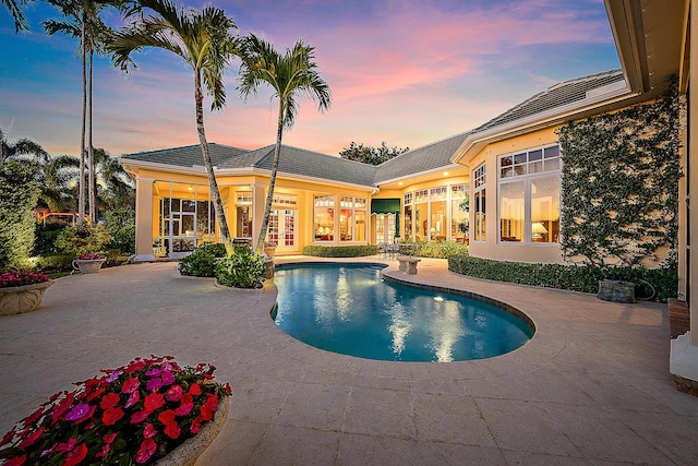 view of pool featuring a patio area and french doors