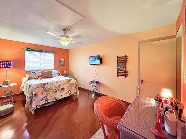 bedroom with wood finished floors and a ceiling fan