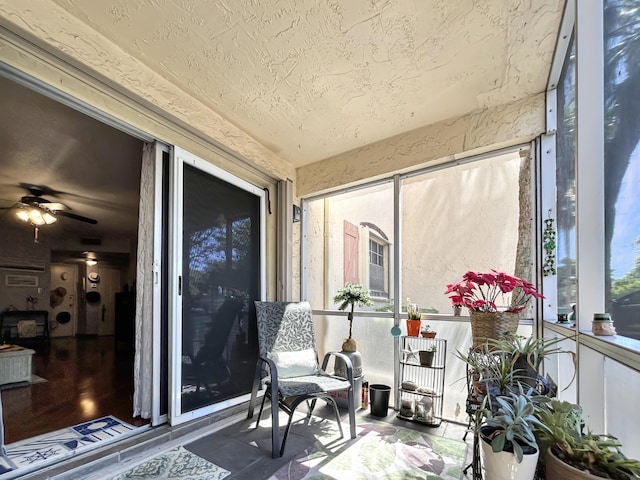 sunroom / solarium with a ceiling fan