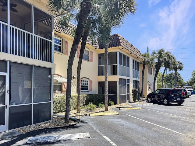 view of property featuring uncovered parking