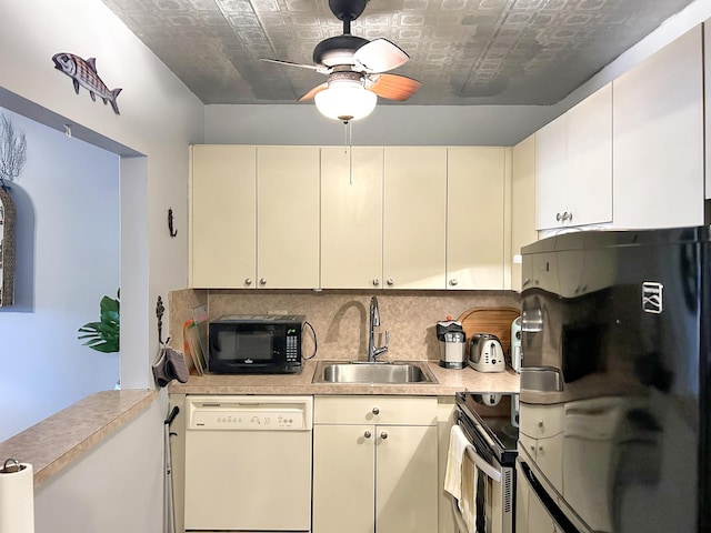 kitchen with tasteful backsplash, light countertops, an ornate ceiling, black appliances, and a sink