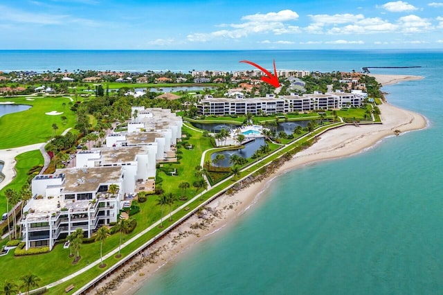 birds eye view of property with a water view and a view of the beach