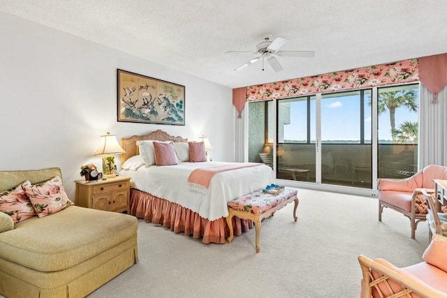 carpeted bedroom with access to exterior, a ceiling fan, and a textured ceiling