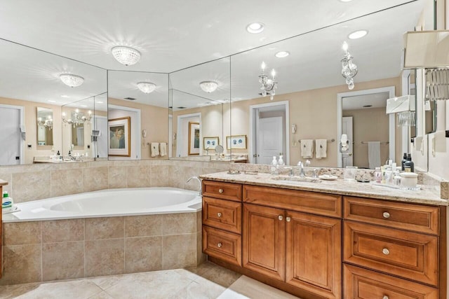 bathroom with tile patterned floors, a garden tub, recessed lighting, and vanity