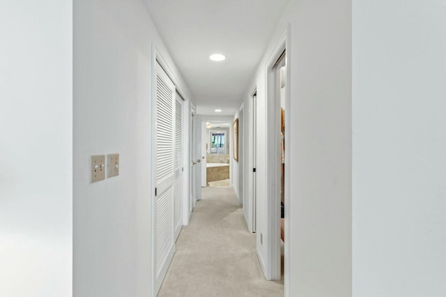 hall featuring recessed lighting and light carpet