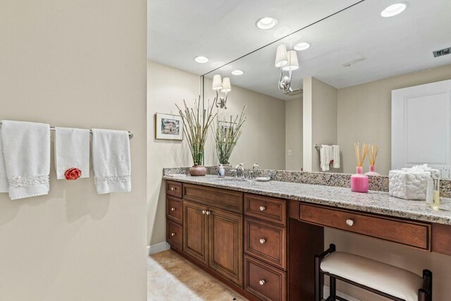 bathroom featuring vanity, recessed lighting, visible vents, and baseboards