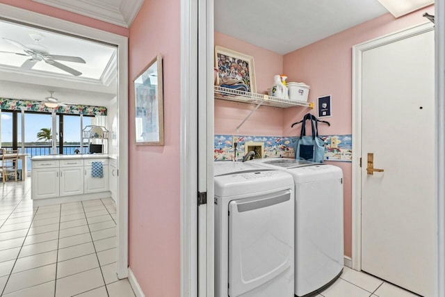 laundry room with ceiling fan, washing machine and dryer, ornamental molding, light tile patterned floors, and laundry area