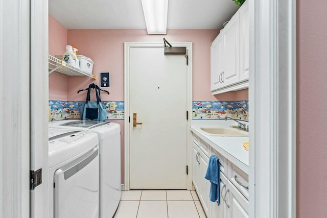 clothes washing area with light tile patterned flooring, a sink, cabinet space, and separate washer and dryer