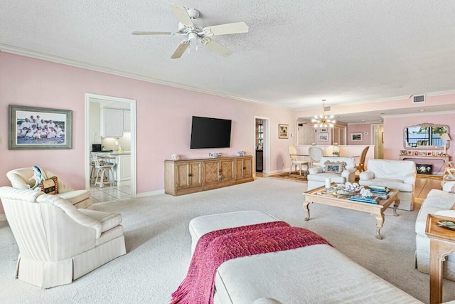 living area featuring visible vents, ornamental molding, carpet flooring, ceiling fan with notable chandelier, and a textured ceiling