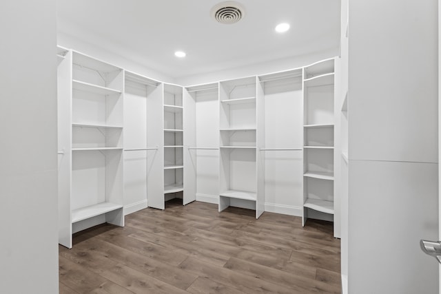 walk in closet featuring wood finished floors and visible vents