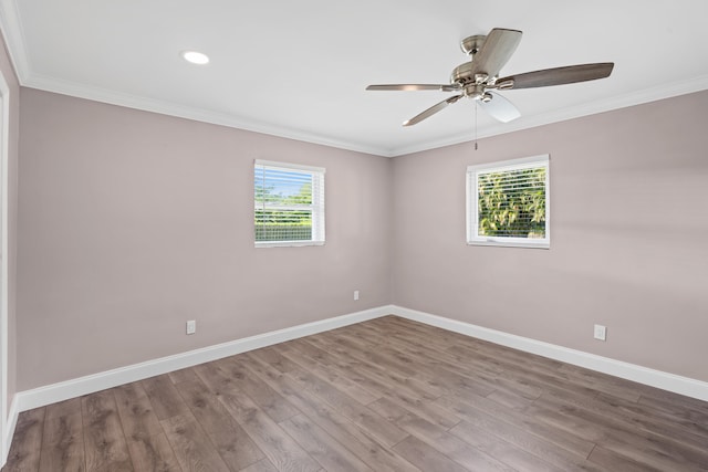 spare room featuring crown molding, plenty of natural light, and baseboards