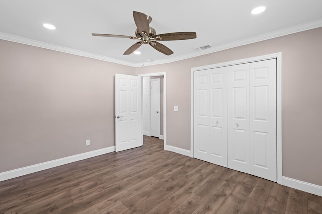 unfurnished bedroom featuring baseboards, dark wood-style flooring, and ornamental molding