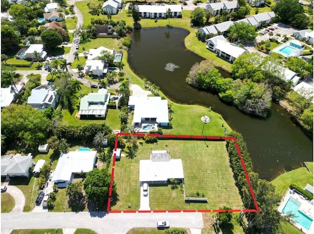 birds eye view of property with a residential view and a water view