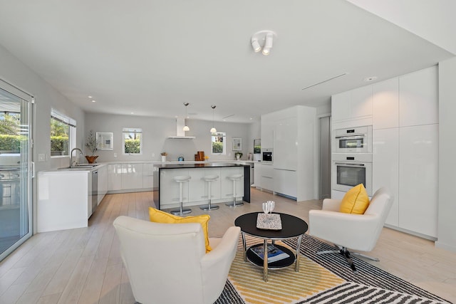 living room with recessed lighting and light wood-style flooring