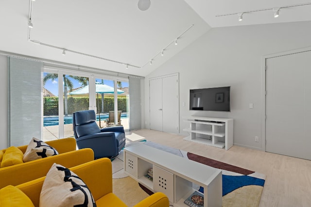 living room featuring high vaulted ceiling, wood finished floors, and track lighting