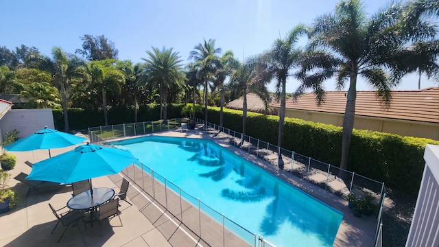 pool featuring a patio area and fence