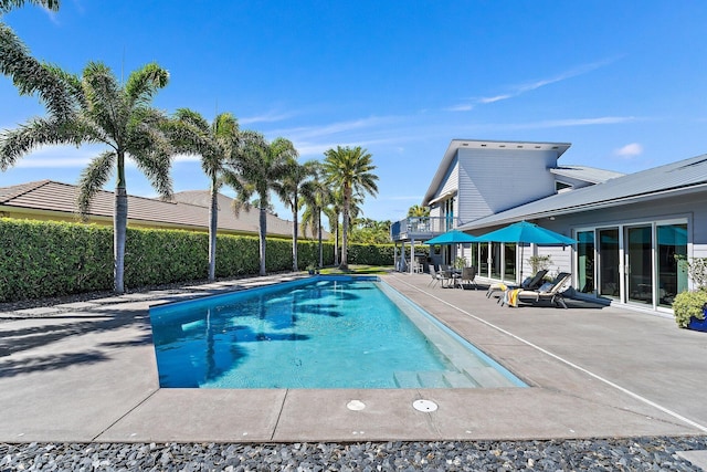 view of pool featuring a patio area, a fenced in pool, and fence