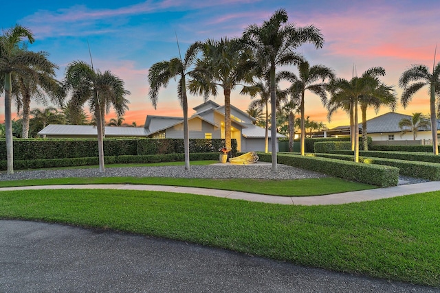 view of community featuring a yard and driveway