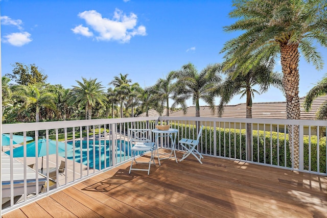 wooden terrace with a swimming pool