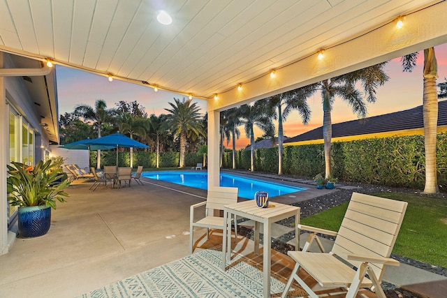 view of swimming pool with a patio, outdoor dining area, a fenced in pool, and a fenced backyard