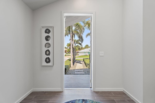 entryway with baseboards and wood tiled floor