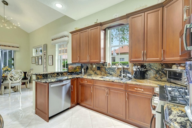 kitchen featuring a wealth of natural light, brown cabinetry, appliances with stainless steel finishes, and a sink