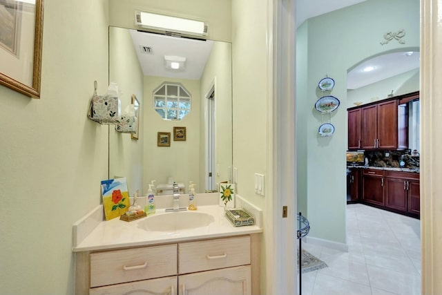 bathroom with visible vents, backsplash, tile patterned flooring, baseboards, and vanity